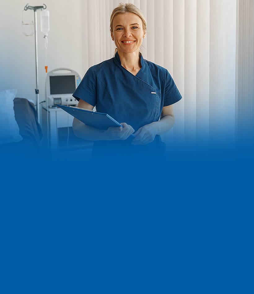 Stomal nurse smiles at the camera holding patient support documents